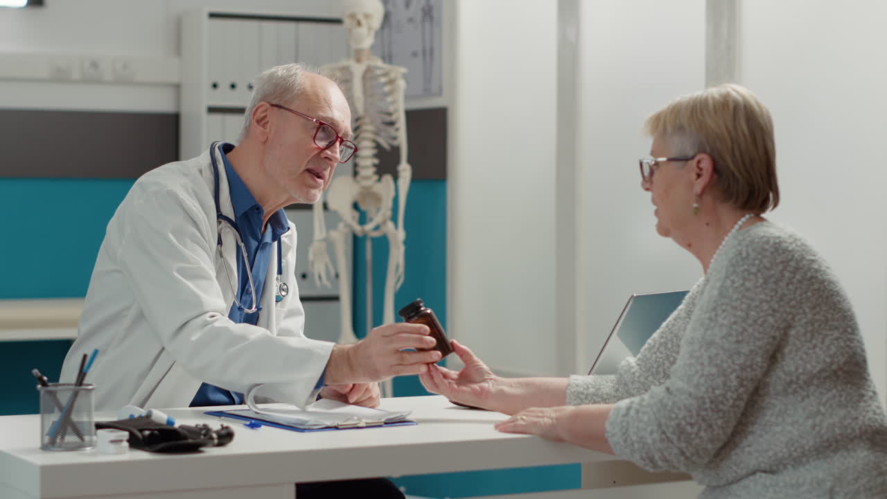 Medical specialist talking about pills treatment with old woman