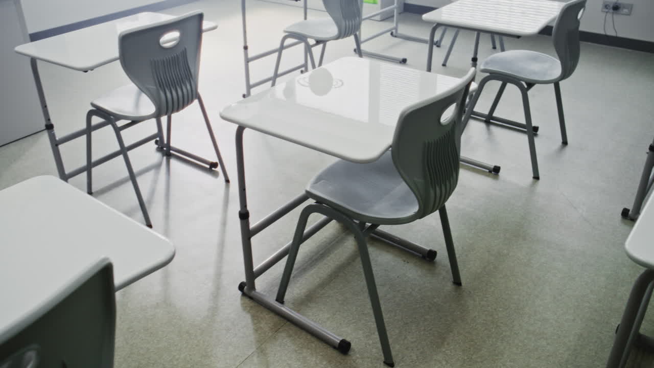 Interior of Modern Empty Elementary School Classroom with Desks for Students