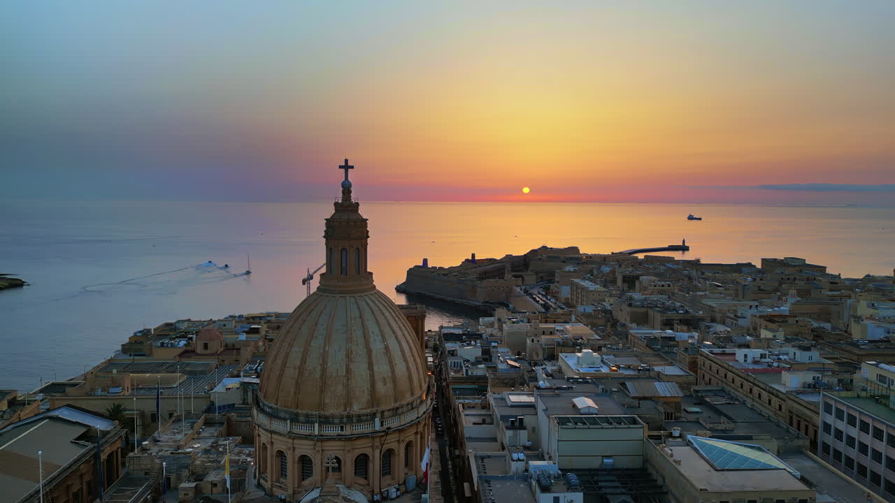 Aerial drone view of the walled city of Valletta, Malta, surrounded by the Mediterranean sea in the evening