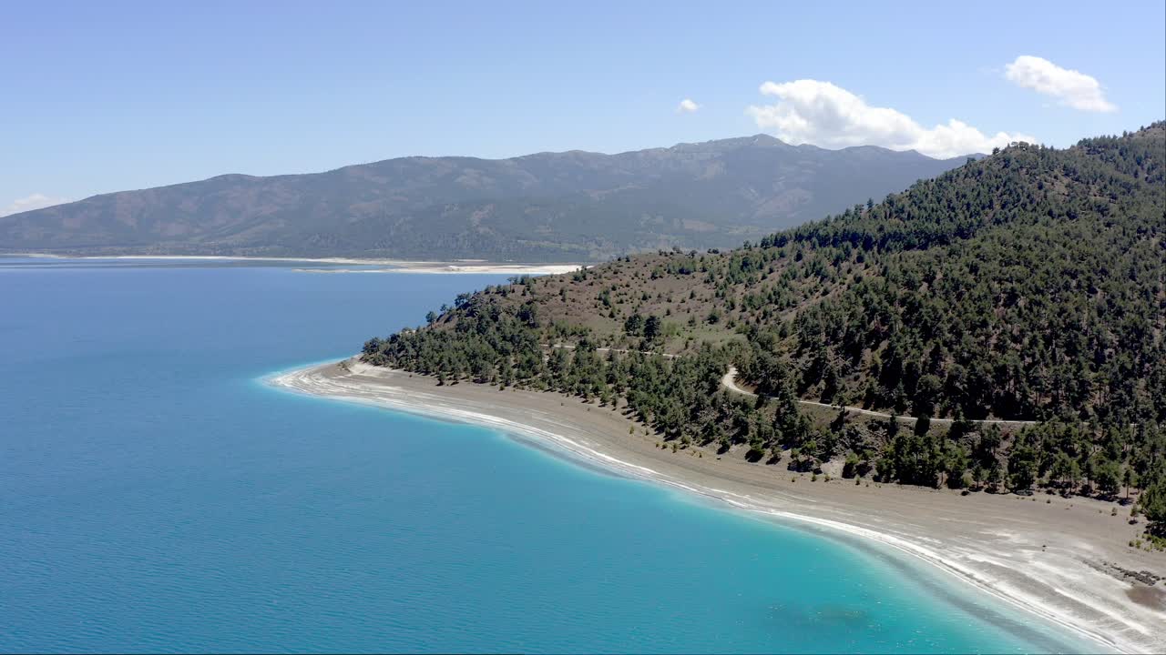 Blue turquoise waters and white shoreline of crater Lake Salda Turkey