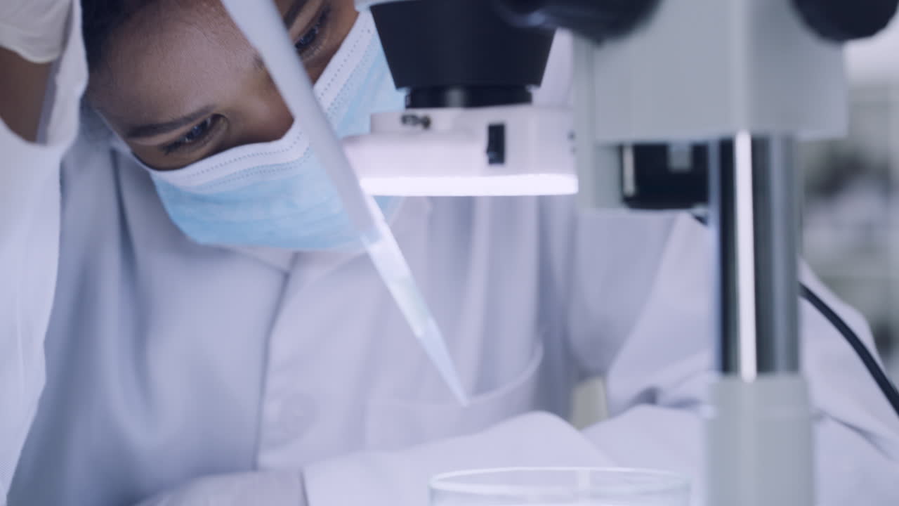 Female scientist using a microscope