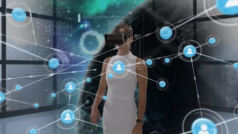 Animation-of-network-of-connections-with-icons-over-businesswoman-wearing-vr-headset