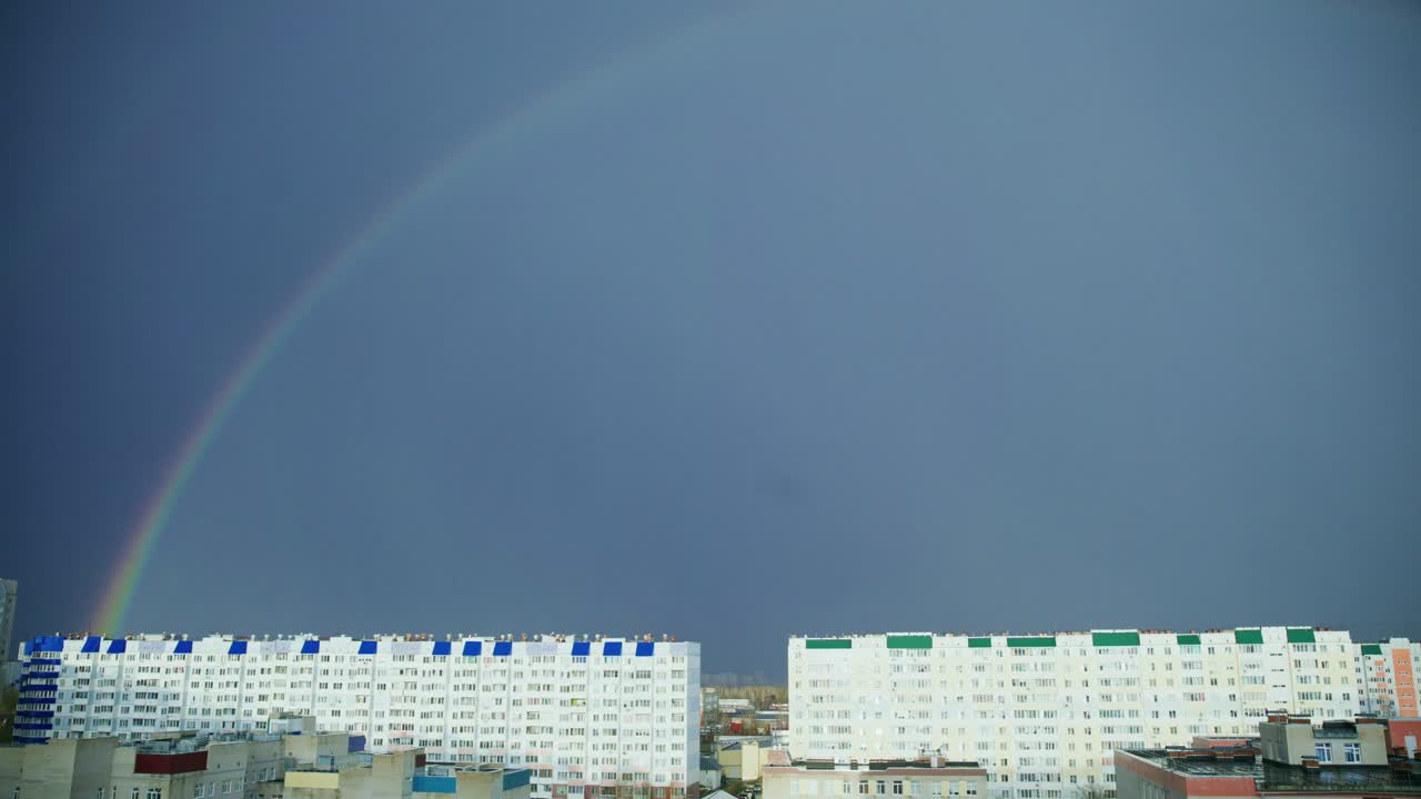 Rainbow over city buildings