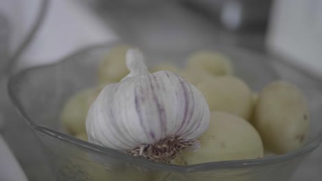 closeup of potatoes and garlic in a bowl, ready to be cooked