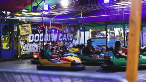 people enjoying bumper cars at a fair