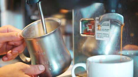 Close-Up-Of-Barista-Frothing-Hot-Milk-To-Add-To-Coffee