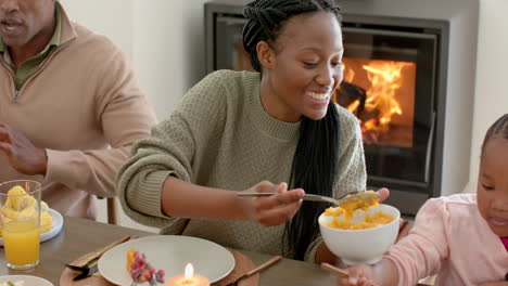 african american parents, children and grandparents celebrating at thanksgiving dinner, slow motion