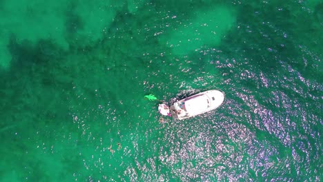 aerial drone view of a family of tourists enjoying vacation over inflatables, doing scuba diving
