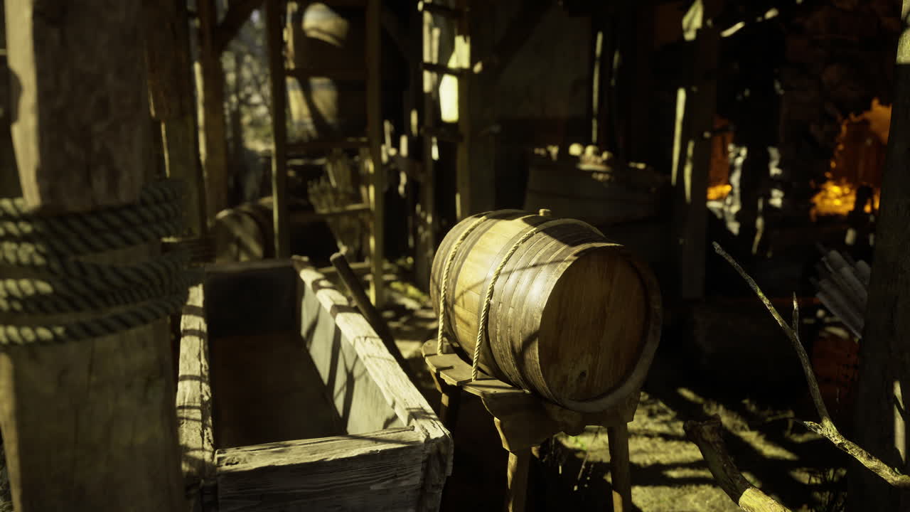 Wooden barrel and trough inside a rustic storage area in an old structure
