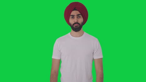 Serious-Sikh-Indian-man-looking-Green-screen