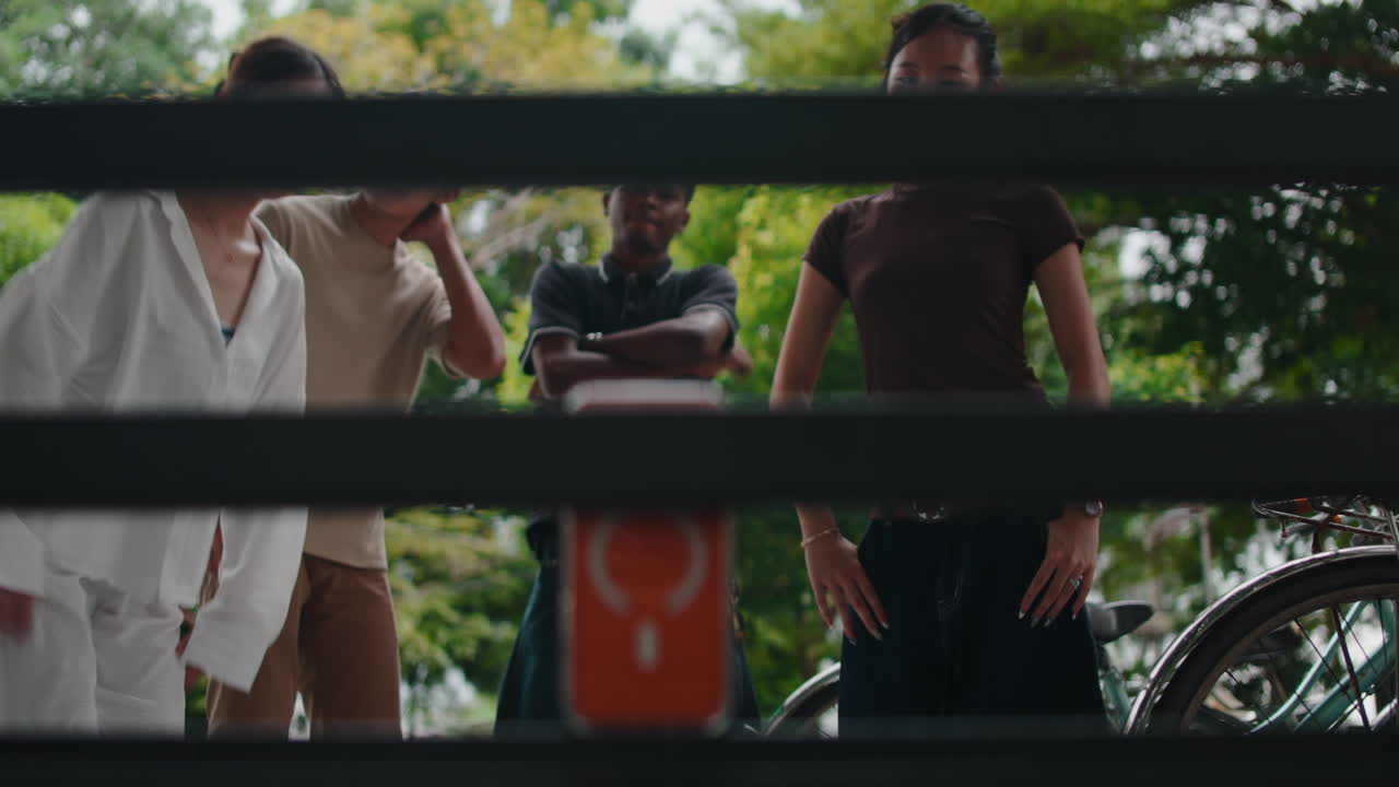 People with an orange box in front of a bicycle