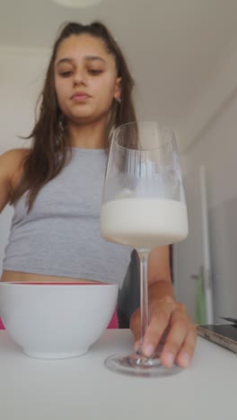 woman pouring milk into a glass