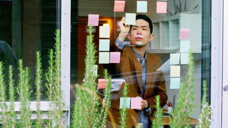 business executive writing on sticky notes