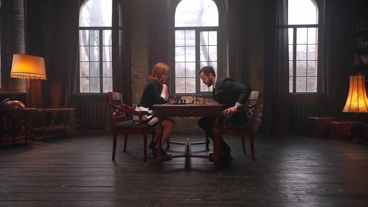 Man and Woman Playing Chess in a Vintage Room