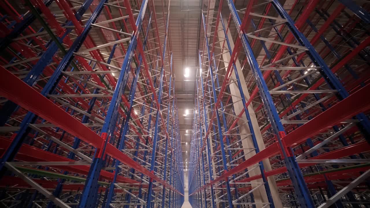 Big and modern warehouse under construction, featuring metal shelving and other industrial equipment.