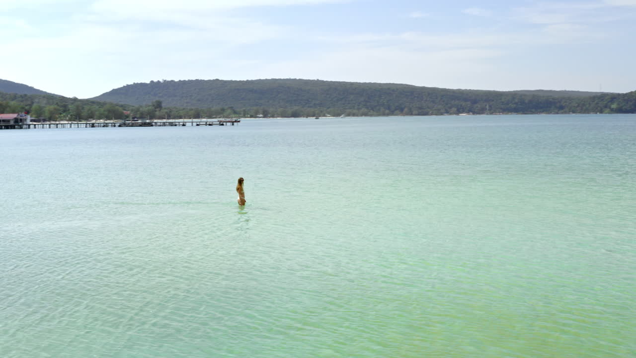 Beautiful Female Model Walks In Water On Tropical Island, Cambodia.