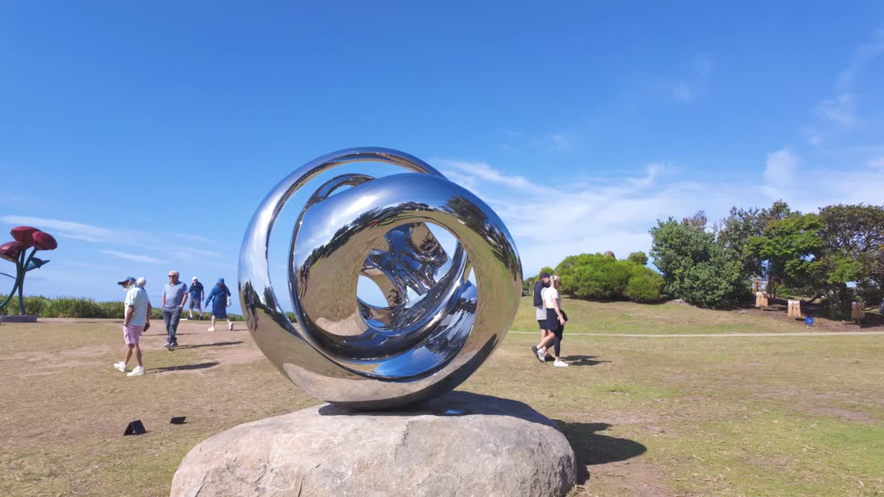 Reflective Metal Sculpture in a Park with Ocean View