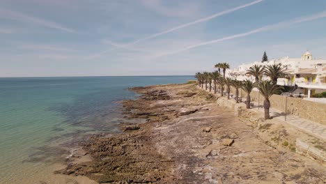 promenade along rocky algarve coast in pescadores avenue, praia da luz. aerial