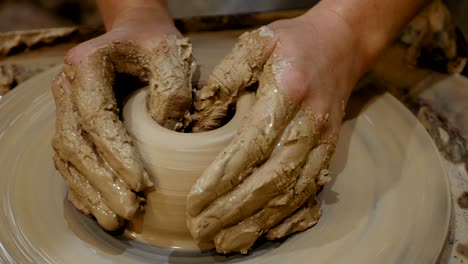 potter is making clay pot on the potter's wheel