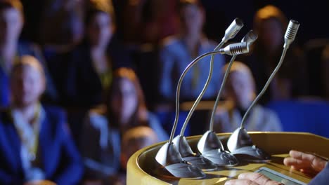 geschäftsmann spricht am podium auf der bühne im auditorium 4k