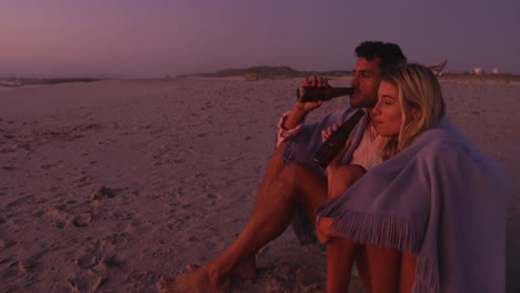 Pareja-Caucásica-Disfrutando-Del-Tiempo-En-La-Playa-Durante-La-Puesta-De-Sol