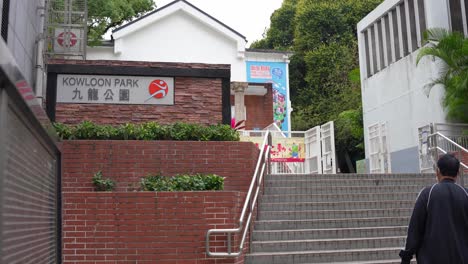 Man-walking-the-stairs-to-Kowloon-park