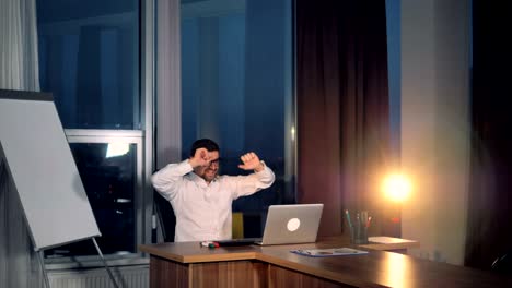 a businessman makes a victory dance after successful work.