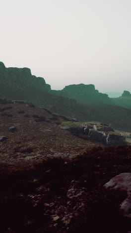 a view of a mountain with a foggy sky in the background