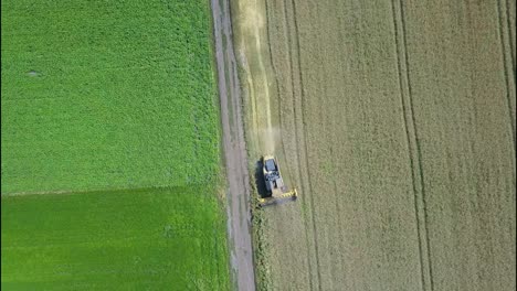 aerial view of a combine harvester working in a field