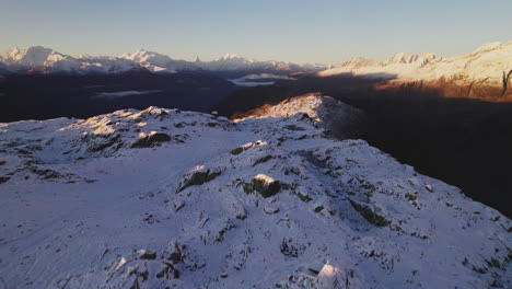 Aerial-View-of-Tourist-On-Aletsch-Glacier-Summit-in-Swiss-Alps-at-Sunrise,-Monte-Rosa-Massif-and-Matterhorn-Mountain-in-Horizon