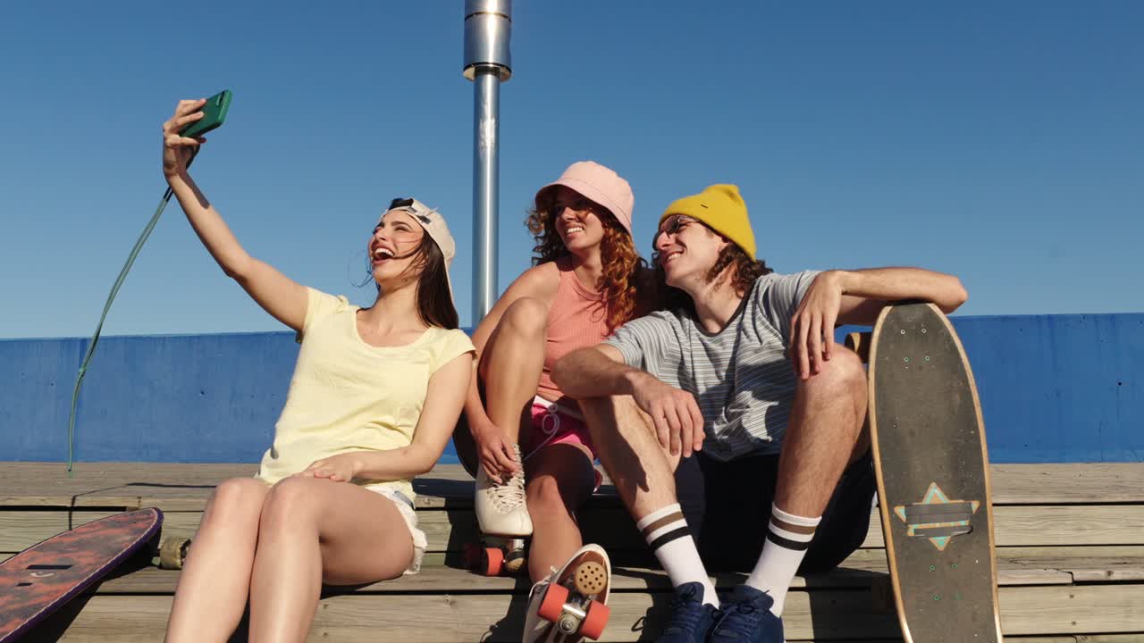 Friends taking a selfie with skateboards and roller skates