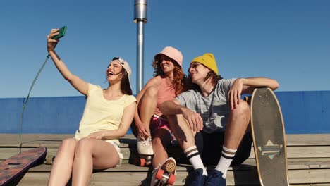 friends taking a selfie with skateboards and roller skates