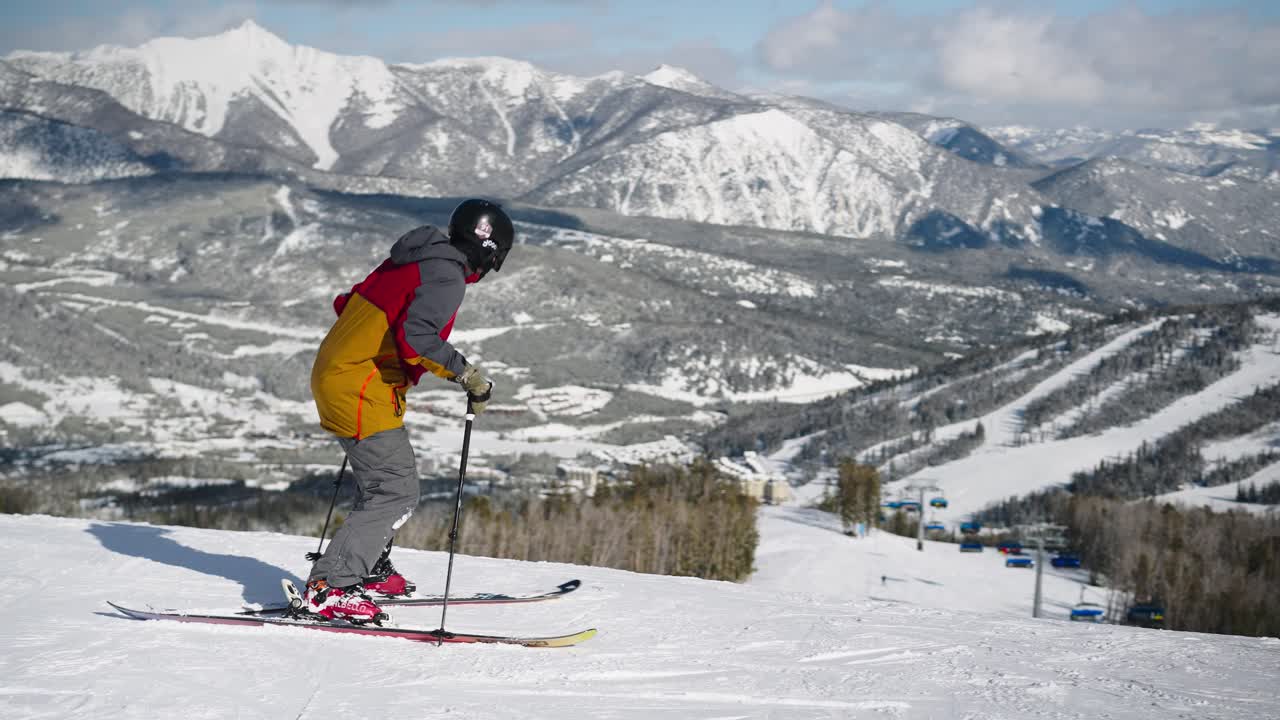 A skier on a nice day skiing fast on a groomed run in Big Sky Montana