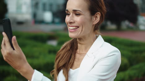 playful businesswoman laughing by video call