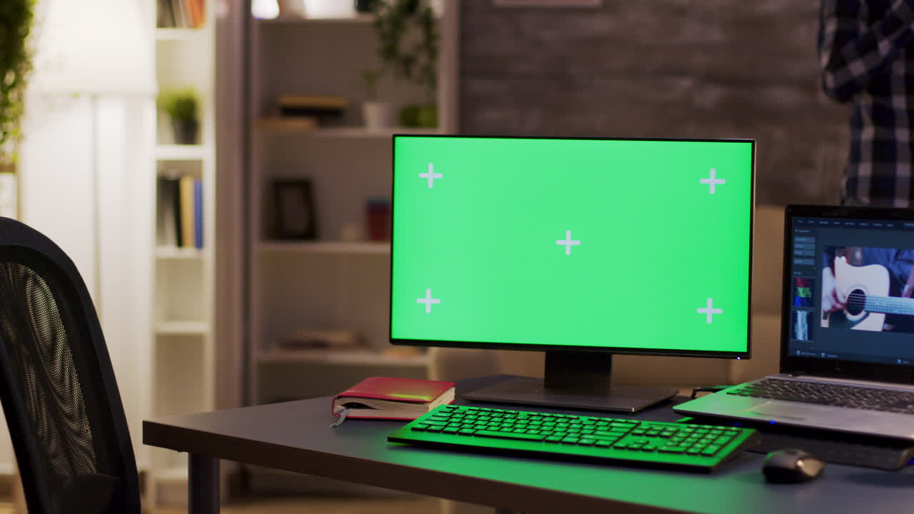 Workspace with Green Screen Monitor and Laptop