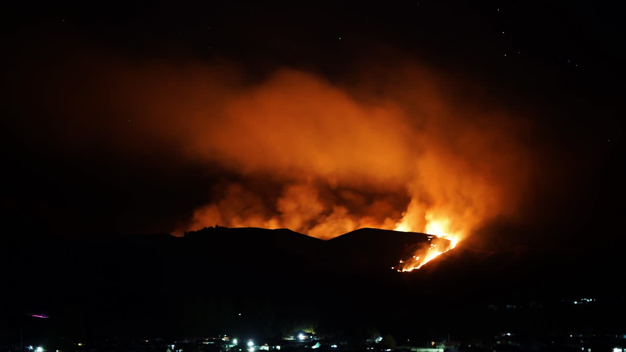 Time lapse of big dangerous flame of fire spreading on the mountain