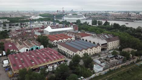 Darwin Ecosystem with Garonne river in background, Bordeaux, cruise ship and city skyline, France. Aerial drone panoramic view