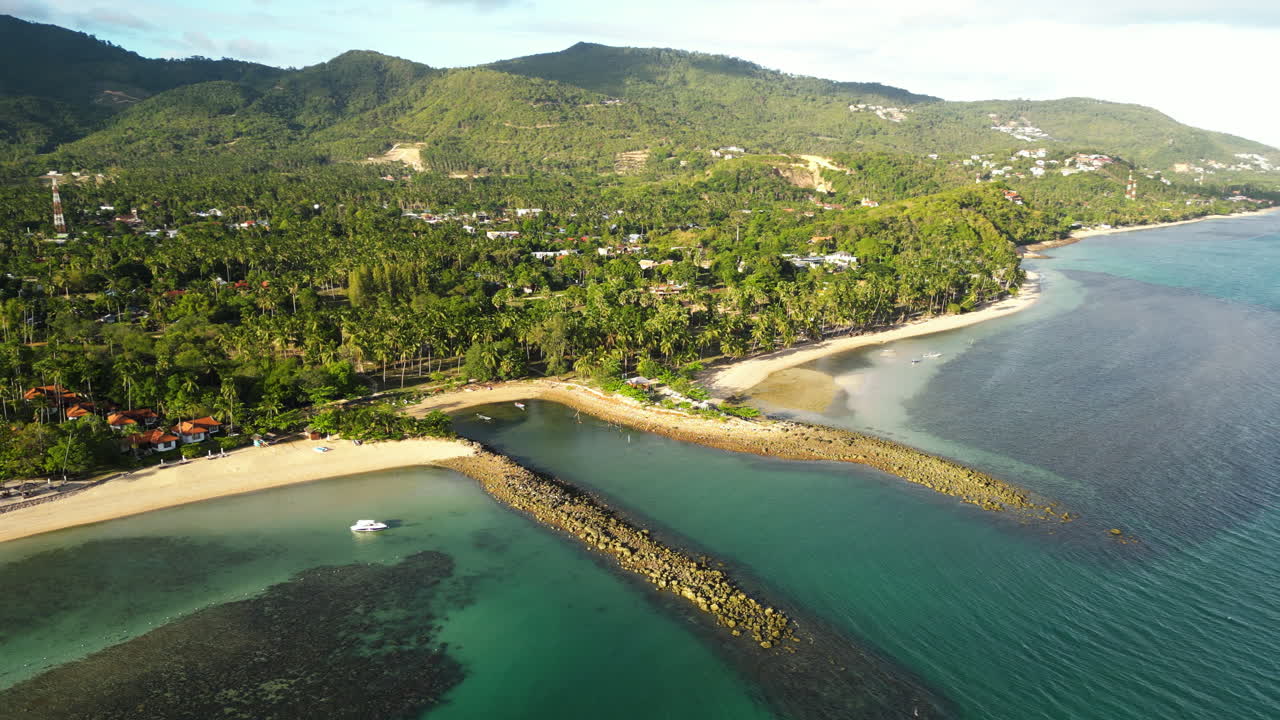 Aerial panorama view of beautiful asian koh samui island with tropical plants , sandy beach and clear ocean water at golden sunset - boat shelter at shoreline