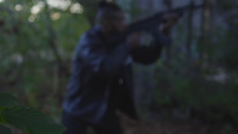 focus-rack-of-black-officer-intently-in-pursuit-with-rifle-raised-as-he-scopes-out-an-abandoned-building