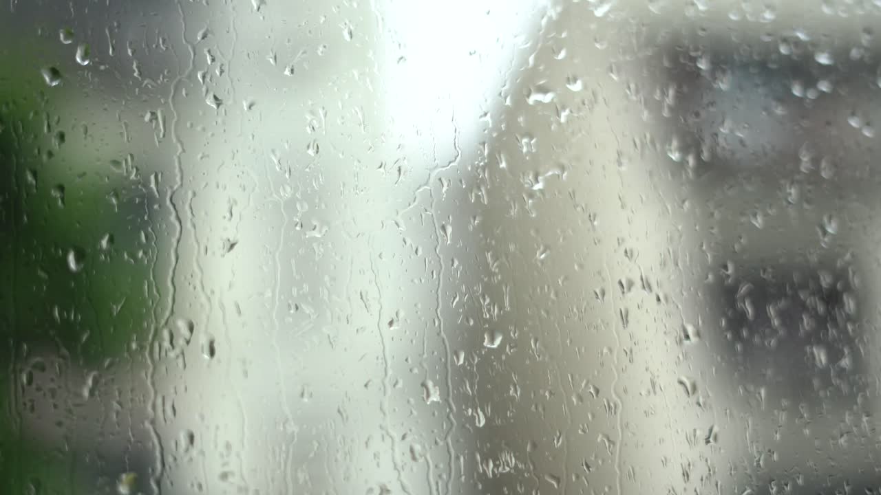 rain water on moving car glass window dripping cinematic b roll