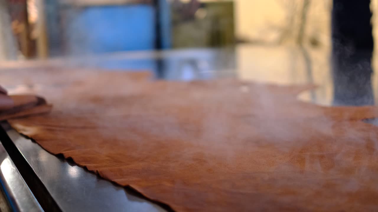 Steaming Leather On The Table Of The Tannery Processing Plant In Ethiopia. - closeup shot
