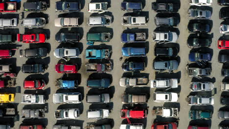 Aerial-drone-view-over-rows-of-vehicles-at-a-salvage-yard