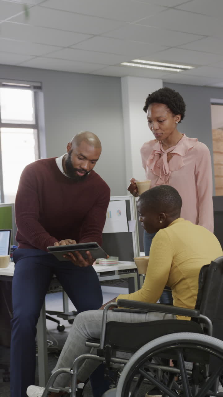 Vertical video of african american business people and disabled woman talking in slow motion