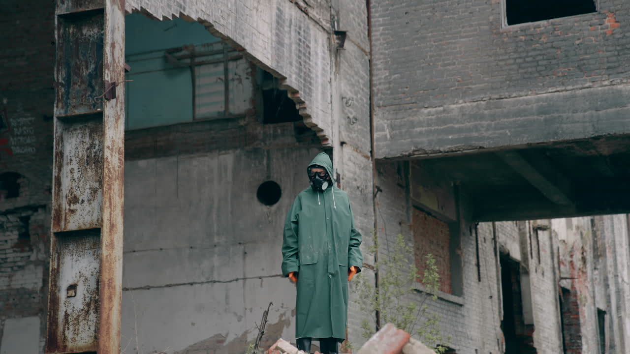 Save our planet. Motion camera view of the human wearing protective mask standing at the abandoned place. Environmental pollution, ecological disaster, nuclear war, post apocalypse concept