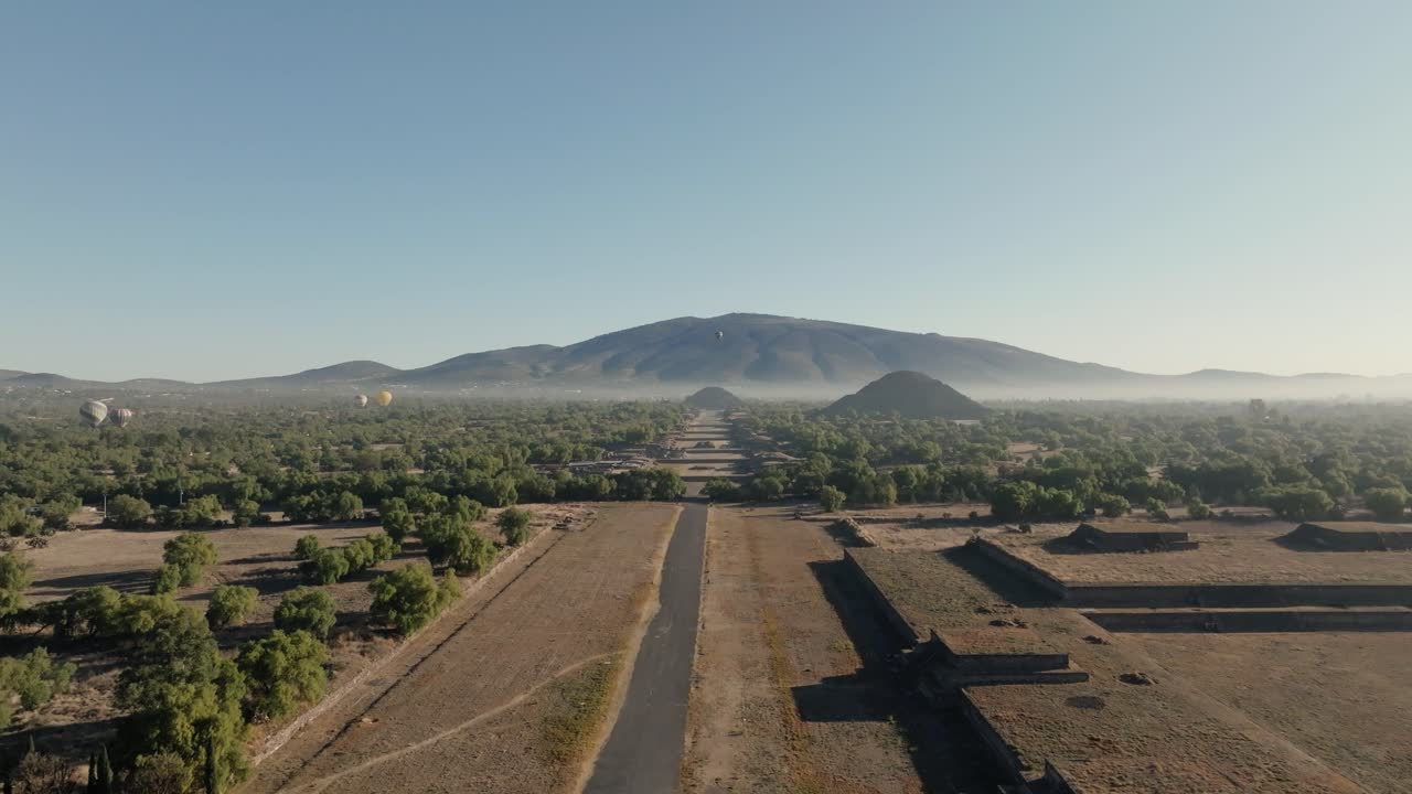 Cinematic Shot Of Teotihuacan City of Gods, Aztec Pyramids, Hot Air Balloons Flying Peacefully, Mexico