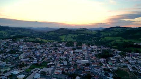 aerial view going forward of bueno brandao city during an golden sunset - bueno brandão is surrounded by serra da mantiqueira