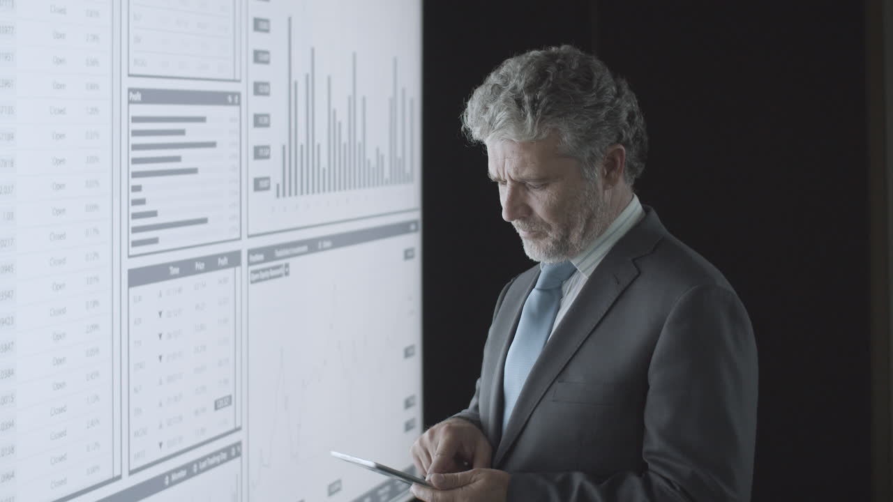 Pensive professional investor thinking over charts