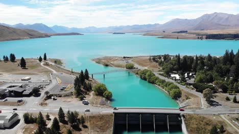 Beautiful-aerial-view-of-dam-and-bridge-in-Lake-Tekapo