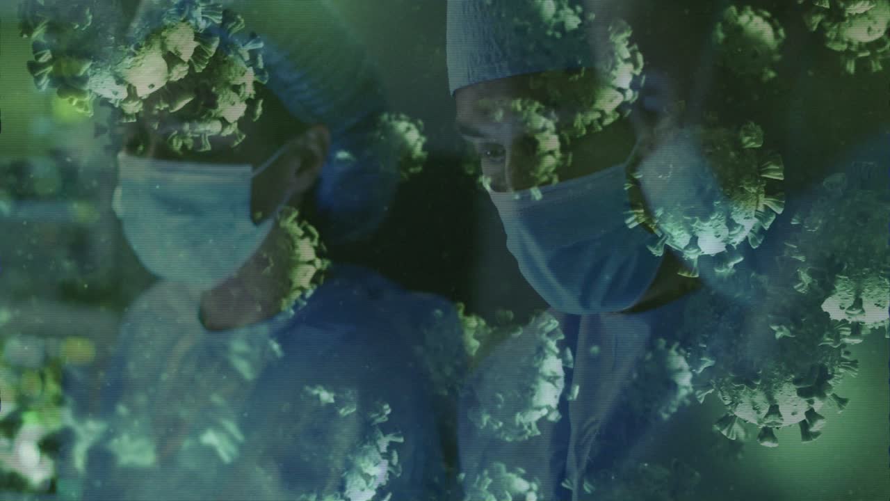 Surgeon checking monitor, colleague joining, both aligning for review, virus overlay covering staff