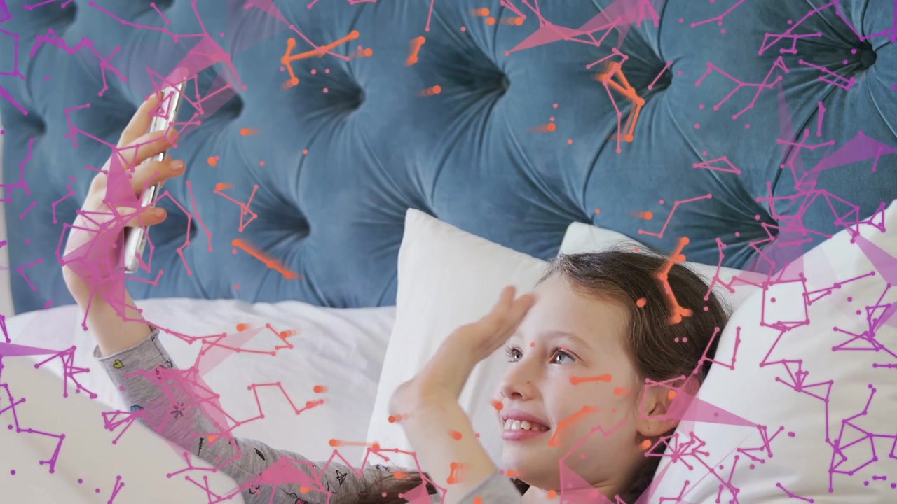 Girl reclining on bed holding smartphone and adjusting angle to explore AR tech overlay around head